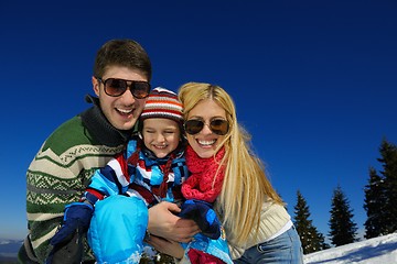 Image showing family having fun on fresh snow at winter vacation