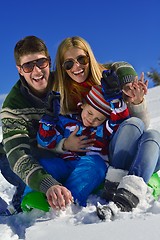 Image showing family having fun on fresh snow at winter vacation