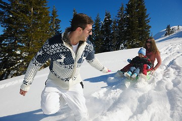 Image showing family having fun on fresh snow at winter vacation