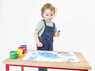 Image showing child looking at painting