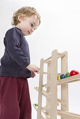 Image showing child playing with wooden ball path