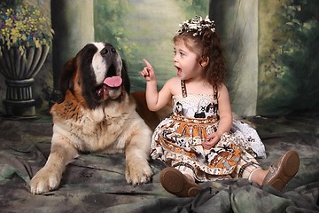 Image showing Adorable Child and Her Saint Bernard Puppy Dog