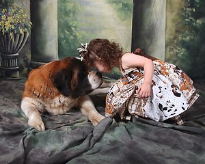 Image showing Adorable Child and Her Saint Bernard Puppy Dog