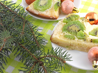 Image showing kiwi cake on plate with christmas balls and new year tree