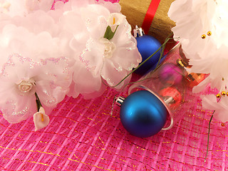 Image showing Golden gift box with white flowers and christmas balls in glass