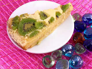 Image showing kiwi tasty cake close up at plate with stones set