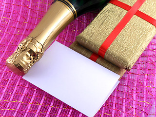 Image showing champagne or wine bottle, blank paper and golden box, New Year or christmas card