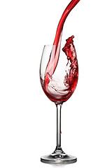 Image showing Splash of wine in glass isolated on white