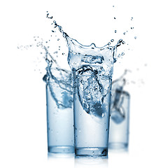 Image showing water splash in glasses isolated on white