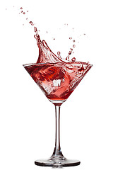 Image showing Red cocktail with splash isolated on white