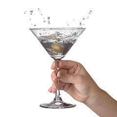 Image showing Martini with splash and olive in womans hand isolated on white
