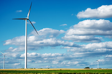 Image showing Wind generator turbines on summer landscape