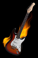 Image showing electric guitar on fire isolated on black