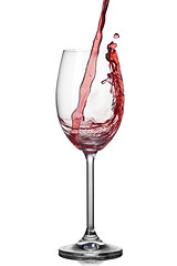 Image showing Splash of wine in wineglass on white