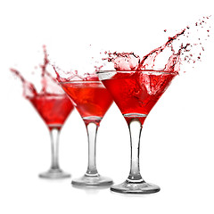 Image showing Red cocktail with splash isolated on white