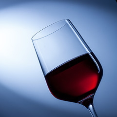 Image showing red wine in glass on blue