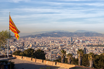 Image showing Aerial view of Barcelona city with flag of Spain