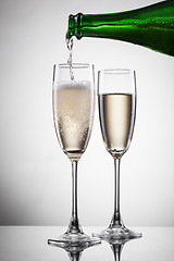 Image showing Champagne pouring into glass isolated on white