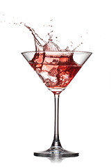 Image showing Red cocktail with splash isolated on white