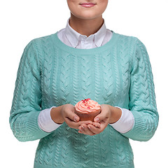 Image showing Woman holding a pink cupcake on white