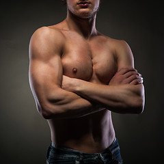 Image showing Muscular naked man on black