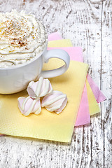 Image showing hot chocolate with marshmallows and cream on wooden background