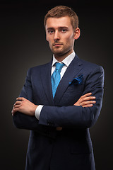 Image showing portrait of handsome businessman on black