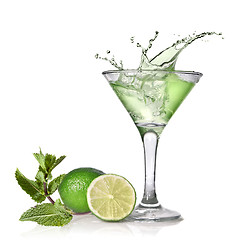 Image showing Green alcohol cocktail with splash, lime and mint isolated on wh