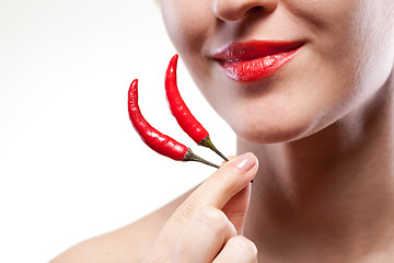 Image showing Young woman with chili pepper isolated on white