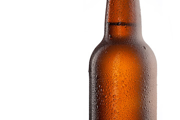 Image showing Beer bottle with water drops and frost isolated on white