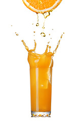 Image showing fresh orange juice splash in the glass isolated on white