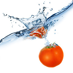 Image showing red tomato dropped into water isolated on white