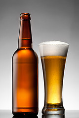 Image showing Beer in glass and bottle on white