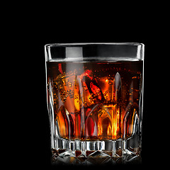 Image showing cola with cognac in glass on black