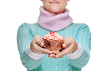 Image showing Woman holding a pink cupcake on white