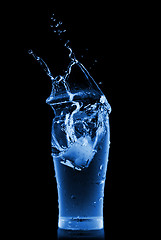 Image showing water splash in glass isolated on black