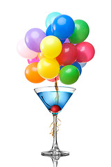 Image showing Blue martini cocktail with color balloons isolated on white