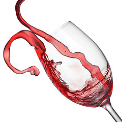 Image showing Splash of red wine in wineglass isolated on white