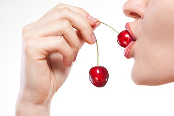 Image showing Young woman with cherry isolated on white