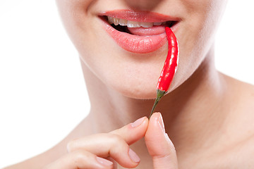 Image showing Young woman with chili pepper isolated on white