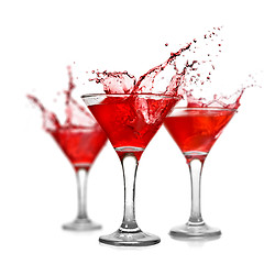 Image showing Red cocktails with splash isolated on white