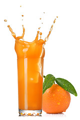 Image showing orange juice splash in glass with tangerine isolated on white
