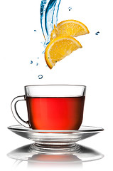 Image showing cup of tea with lemon slices isolated on white