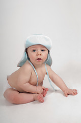 Image showing Baby boy in blue hat sitting