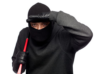 Image showing Burglar with a crowbar on the shoulder.