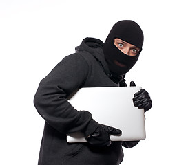 Image showing Thief stealing a laptop computer