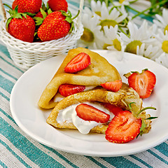 Image showing Pancakes with strawberries on a napkin