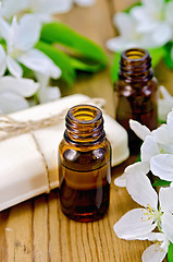 Image showing Oil aromatic and white soap with flowers of apple