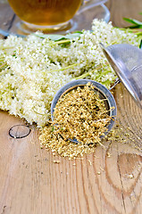 Image showing Herbal tea with meadowsweet strainer and glass cup