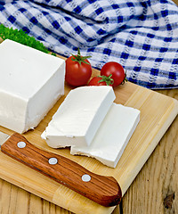 Image showing Feta cheese with tomato on the board and napkin